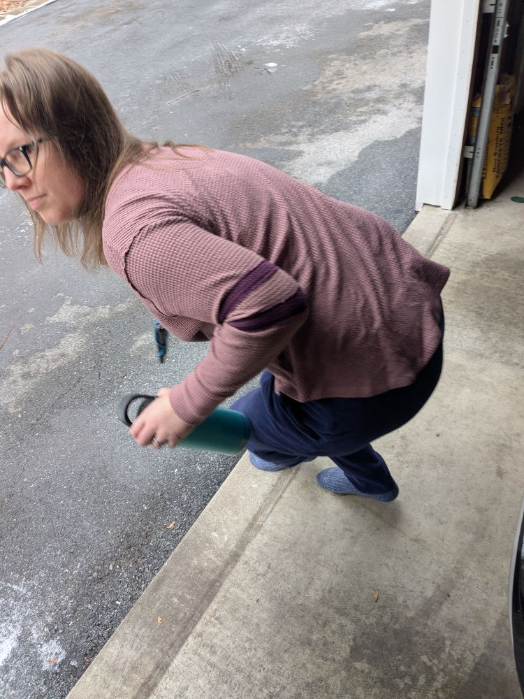 Kelly getting up from in front of car